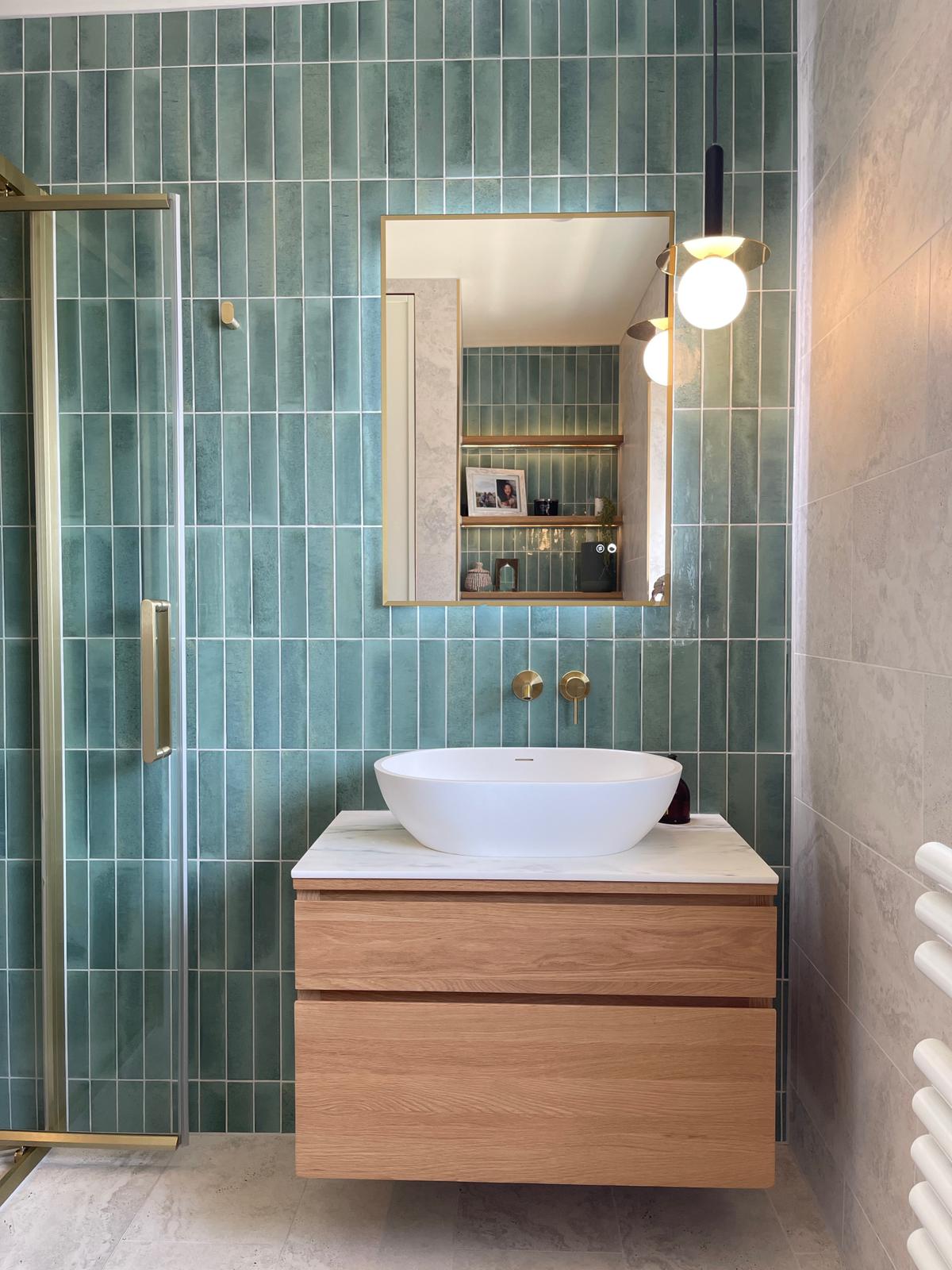 Contemporary bathroom with teal vertical tiling and brass fixtures