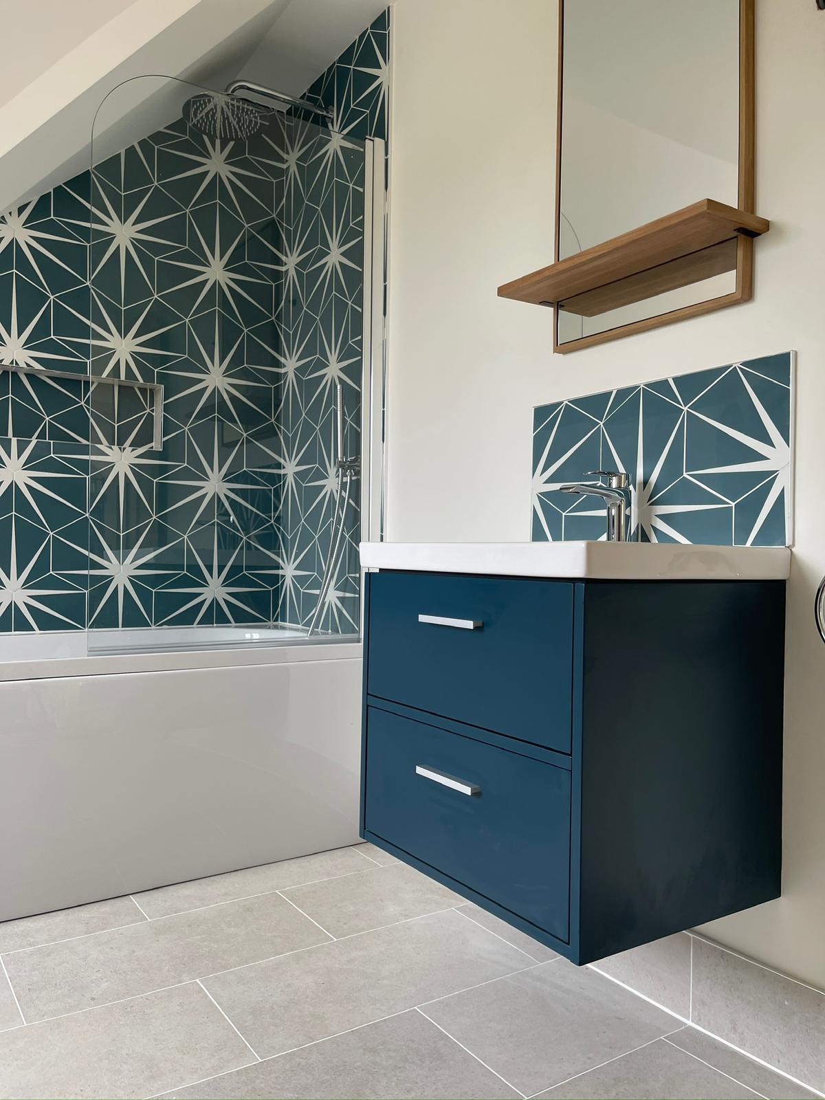 Geometric tiled bathroom with navy vanity unit