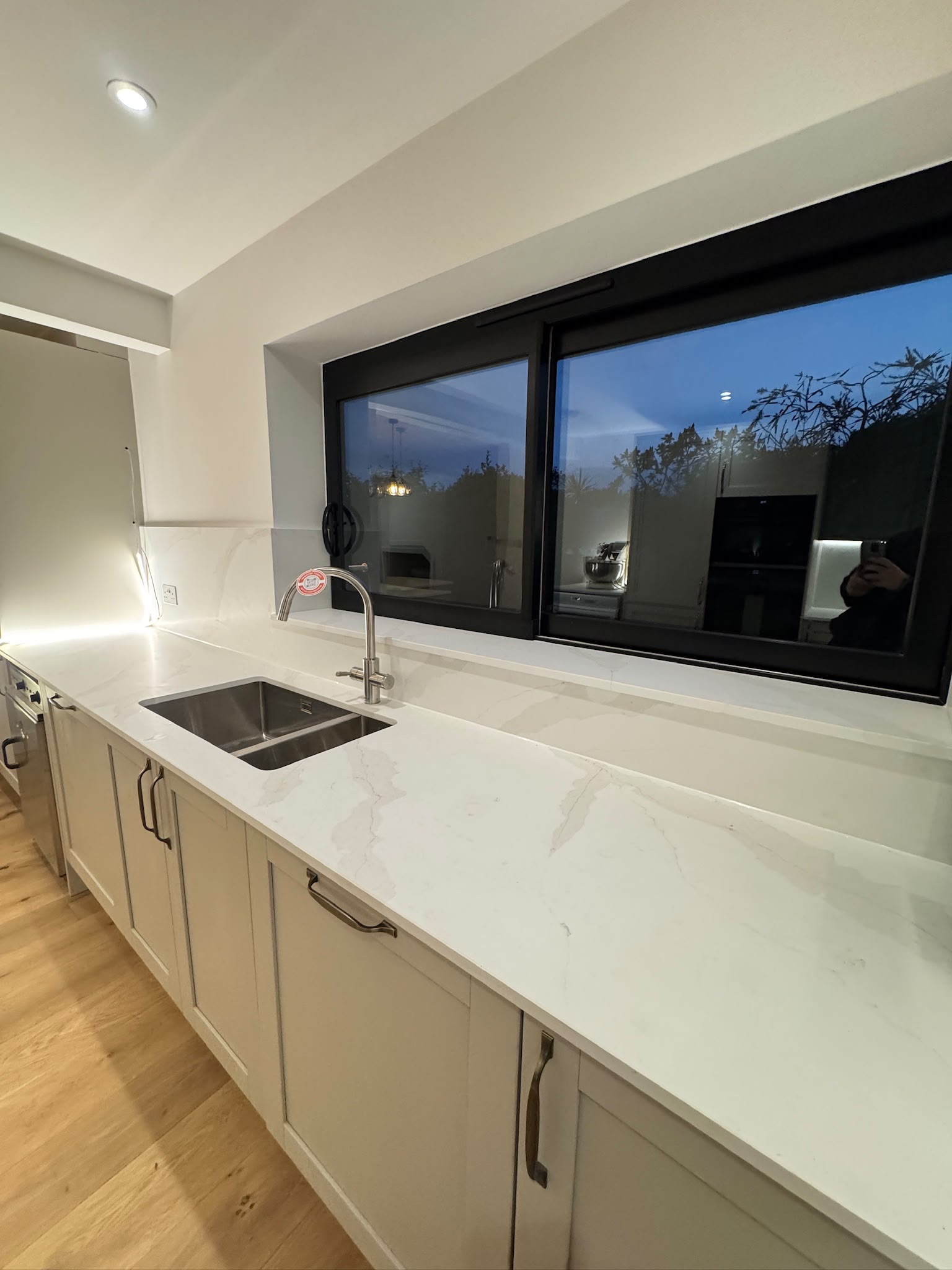 Sink beneath the sliding kitchen window