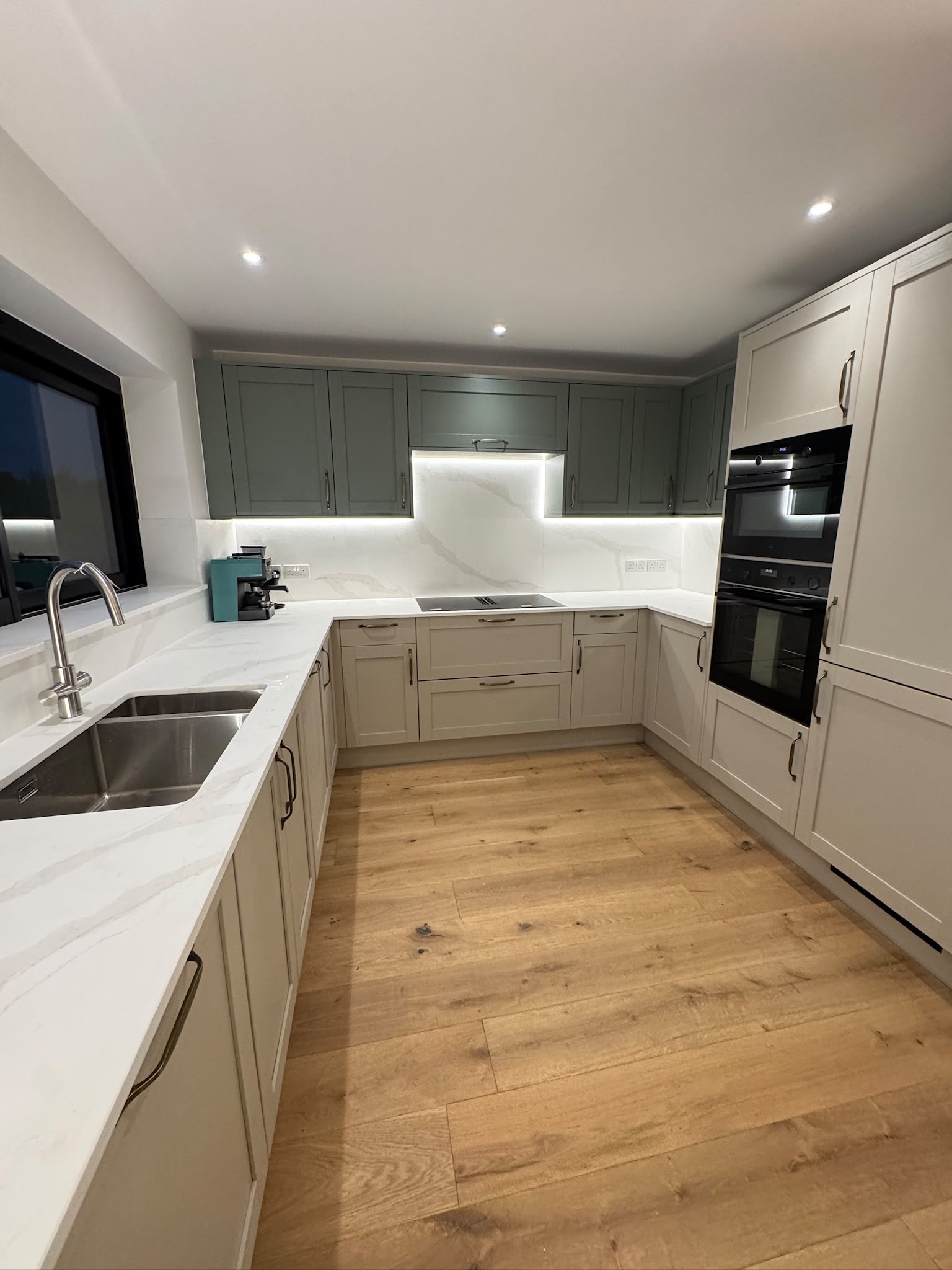 Wall cabinets above a stone splashback with feature LED lighting
