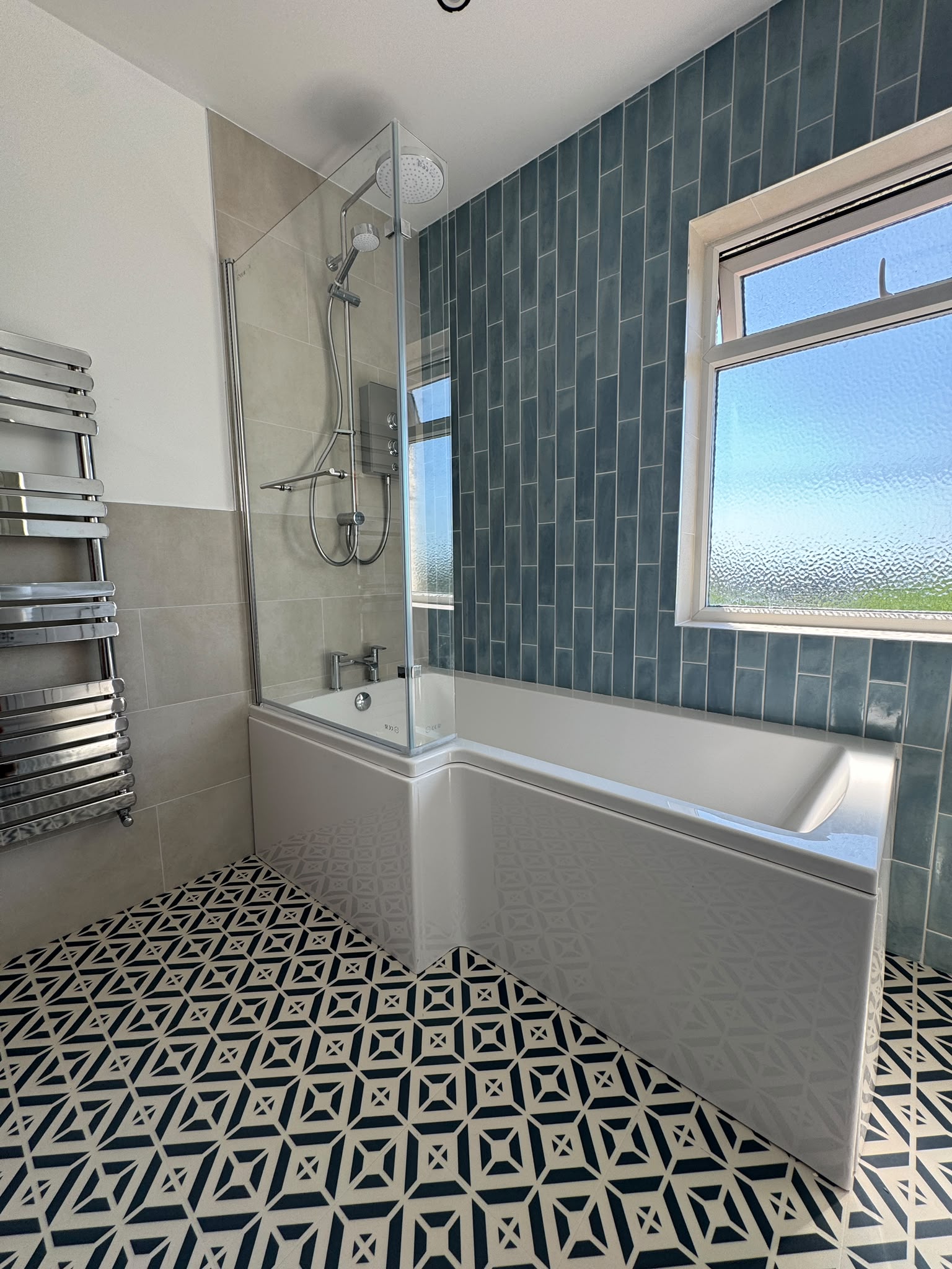 Family bathroom with patterned LVT floor, bath and shower area