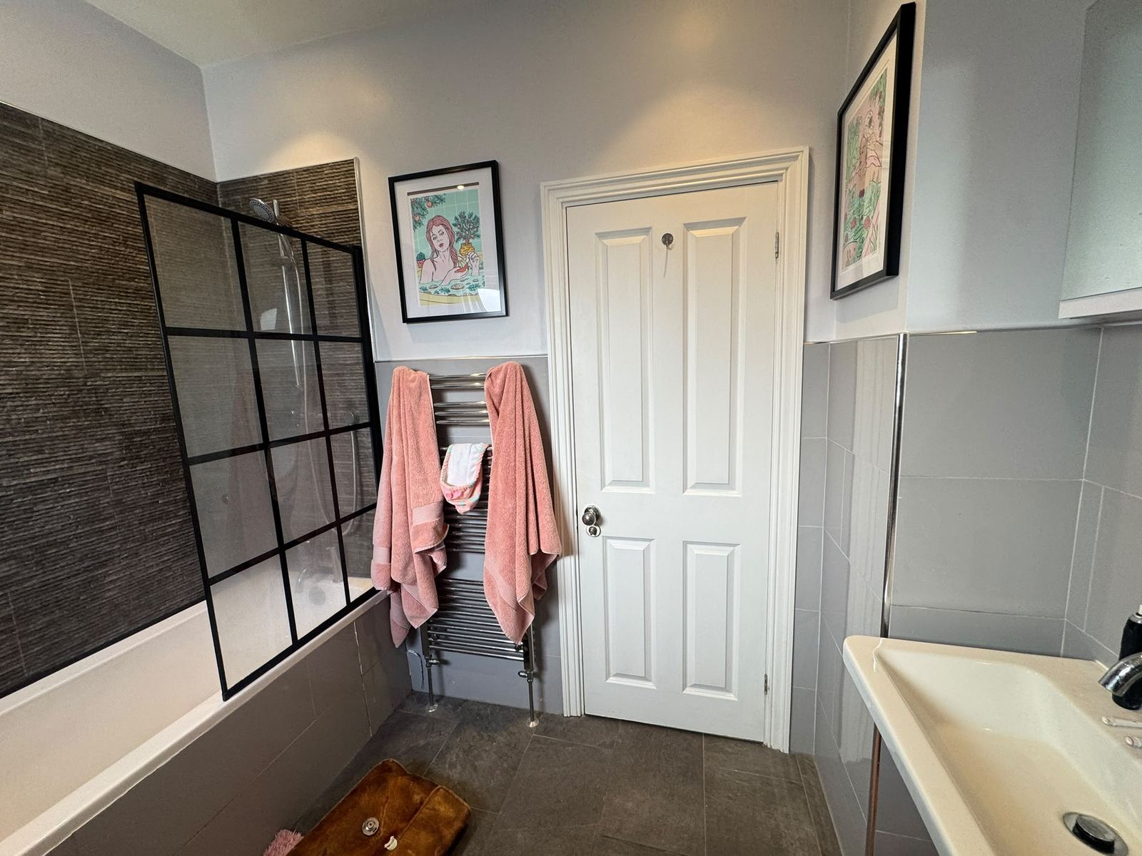 Before: black-framed shower screen over the bath