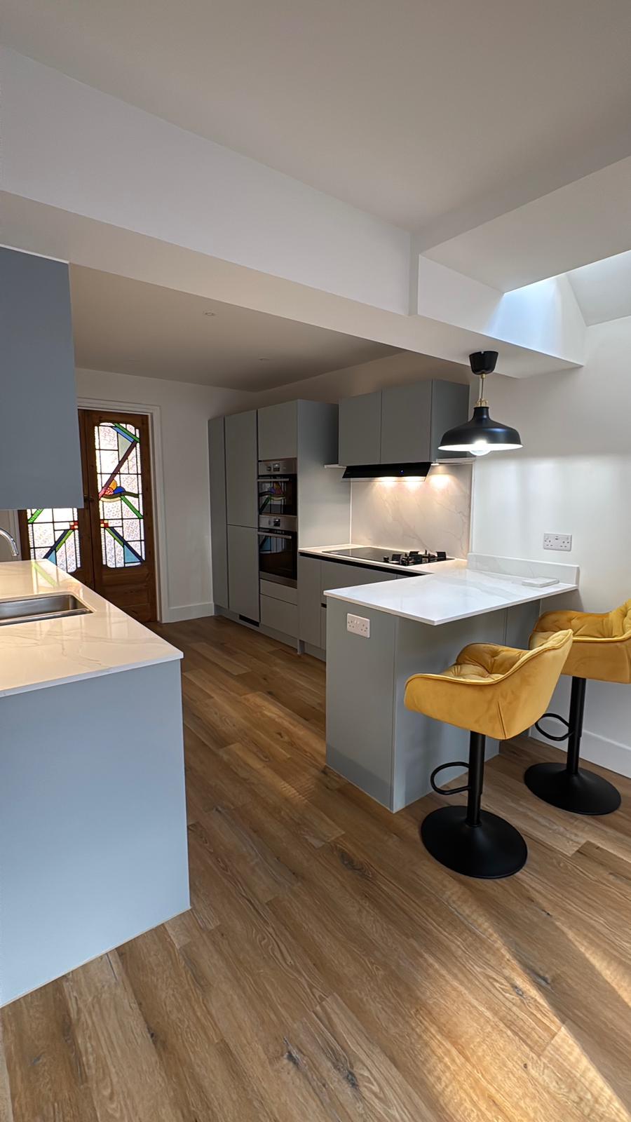 Breakfast bar with yellow stools and a stained-glass door