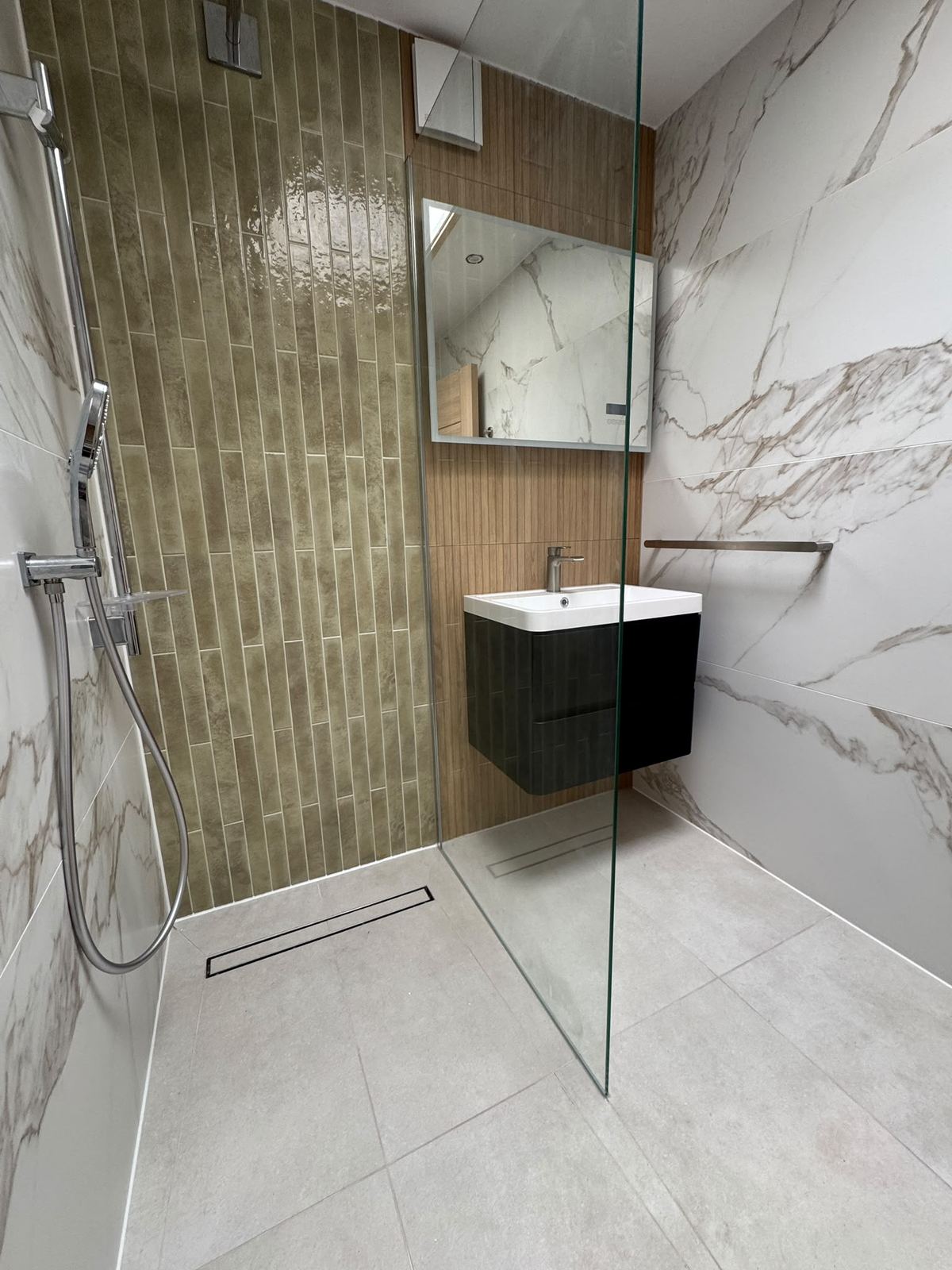 Olive vertical tiled shower column with marble-look surround