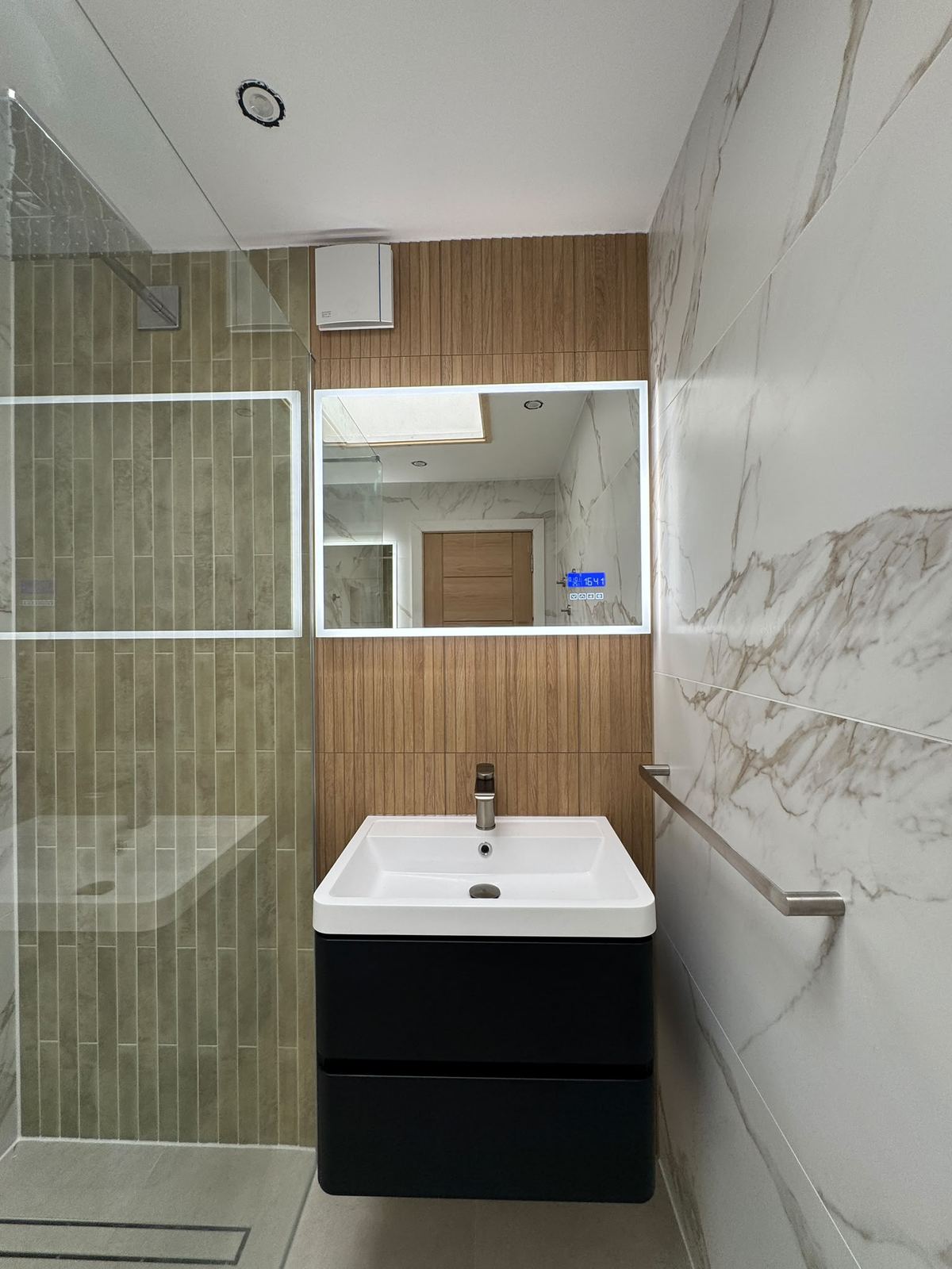 Basin, mirror and shower screen in the finished room