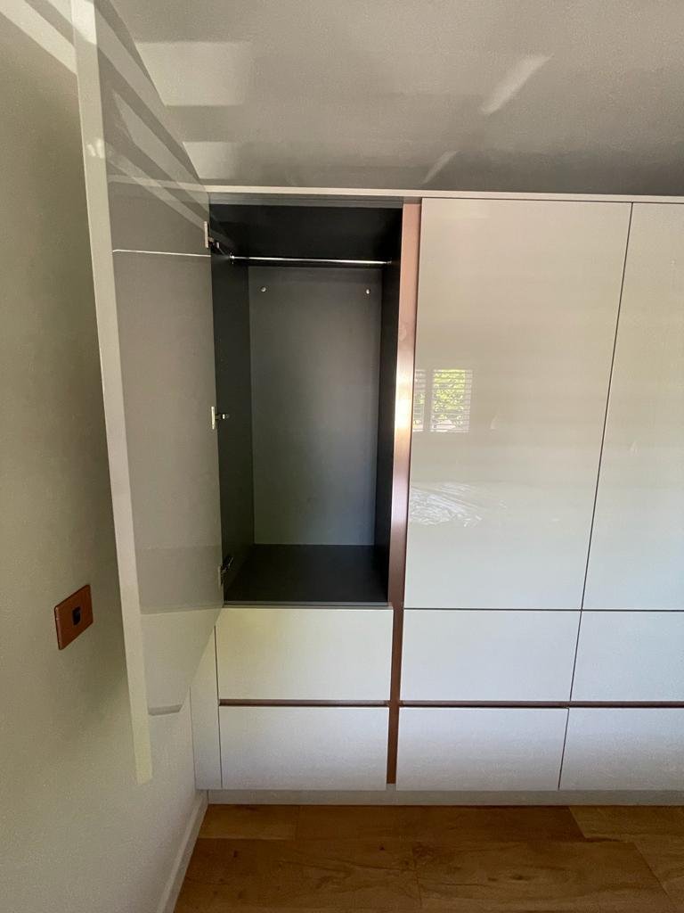 Wardrobe door open, showing the fitted interior