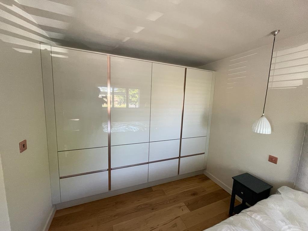 The full run of wardrobes under the sloping ceiling