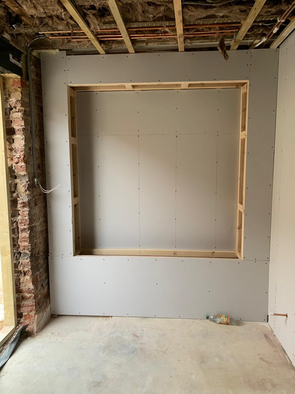 The alcove framed out and boarded, before the shelving went in