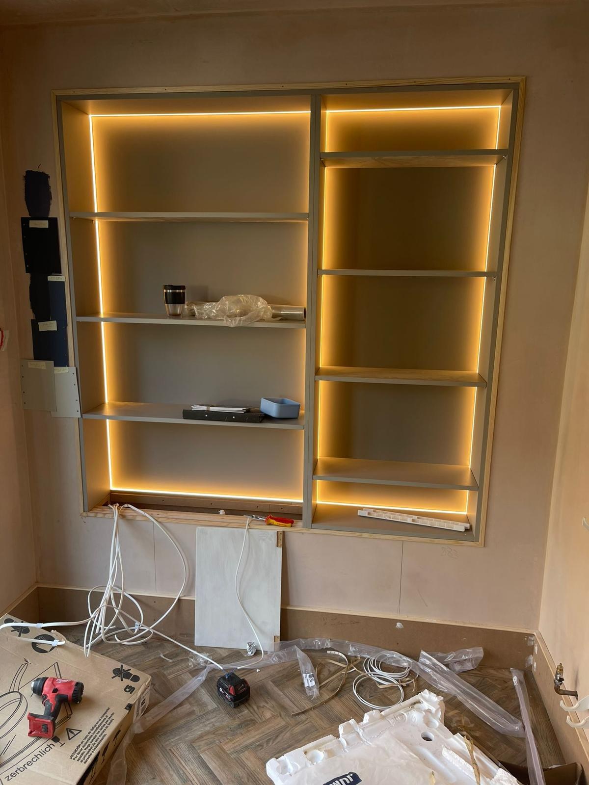 Fitting the shelving: lighting wired in, ready for the final finish