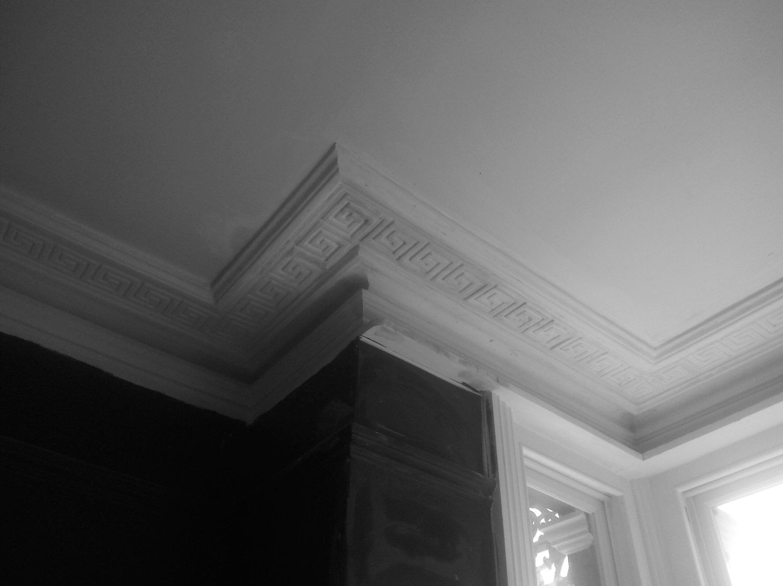 Restored Greek key cornice in a period room